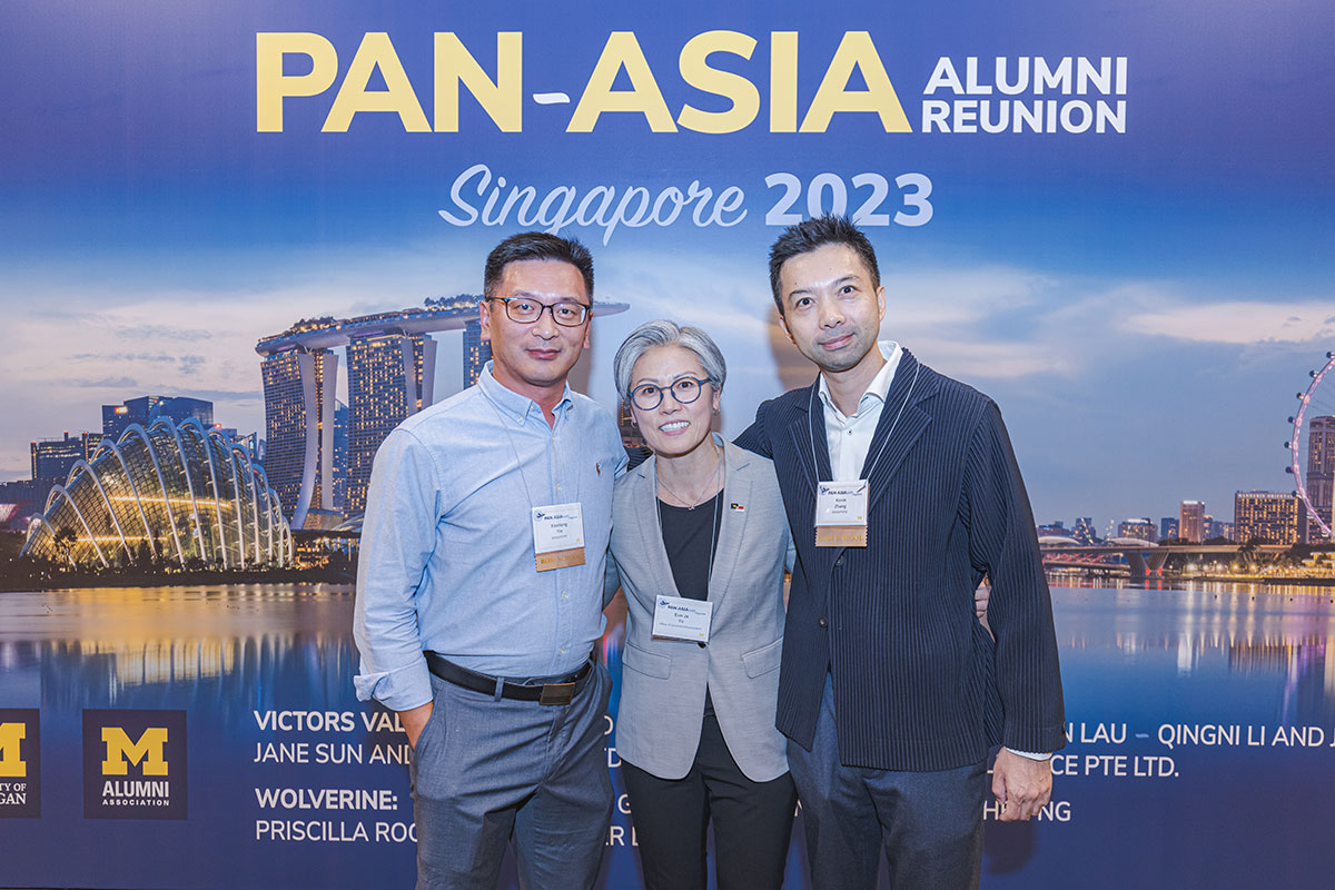 Three people pose for a photo at the 2023 Pan-Asia Alumni Reunion