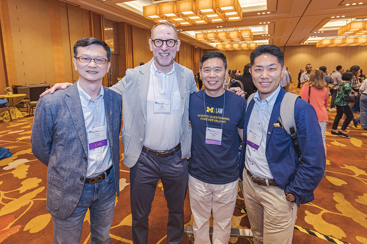 Four people pose for a photo at the 2023 Pan-Asia Alumni Reunion