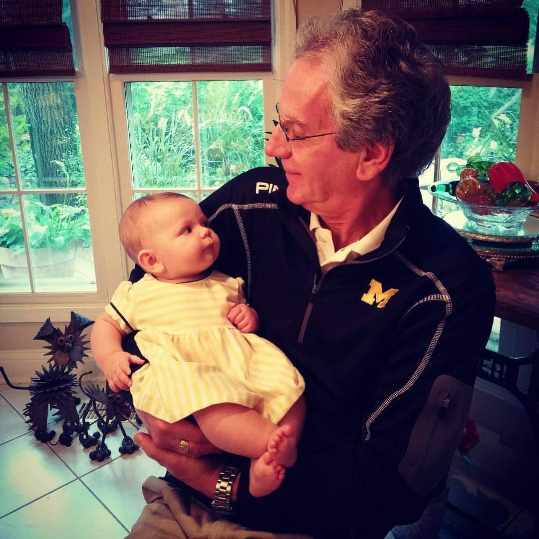 Christine H. Garry, ’74, captured this photo of husband Michael, ’75, DDS’77, holding granddaughter Kyleigh Bryn during a football Saturday at their home in Barrington, Ill. The Garrys’ daughter, Kristen Garry Oziemkowski, ’08, is Kyleigh’s mother