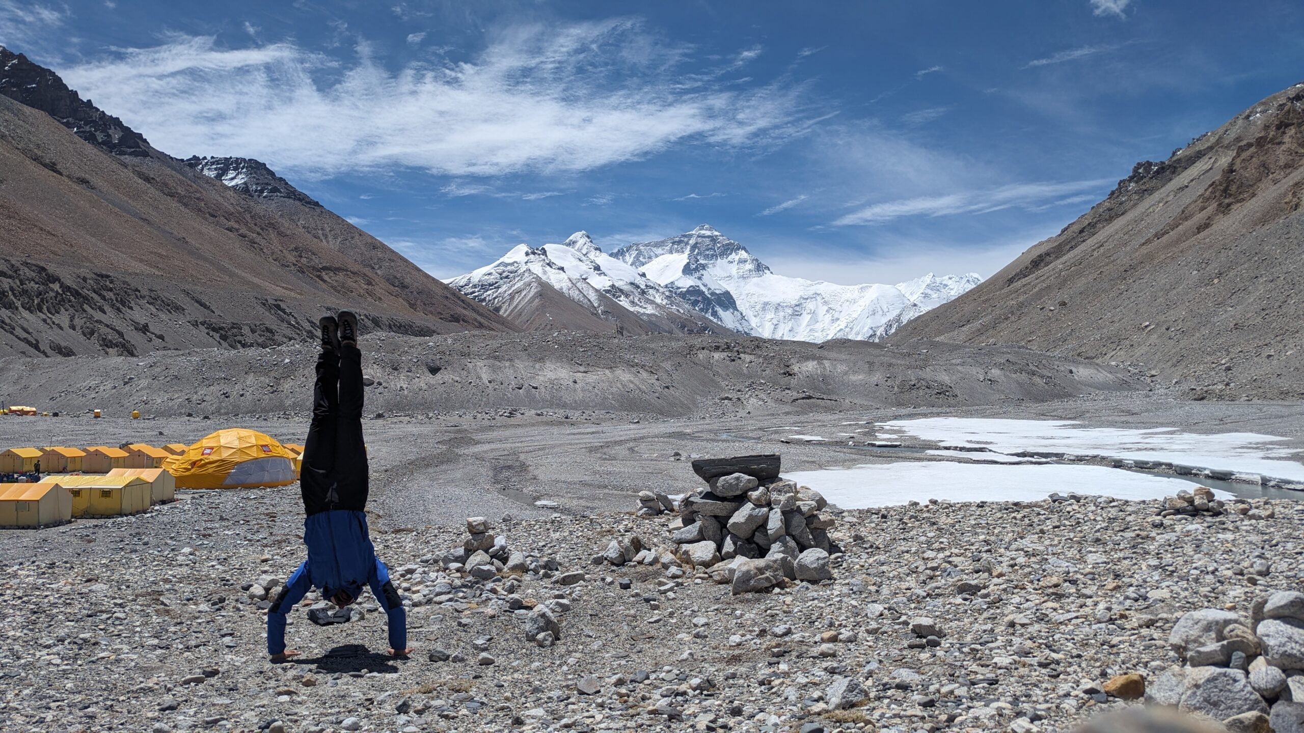 Myra Beaudoin Bertrand does yoga on rocky terrain at base camp.