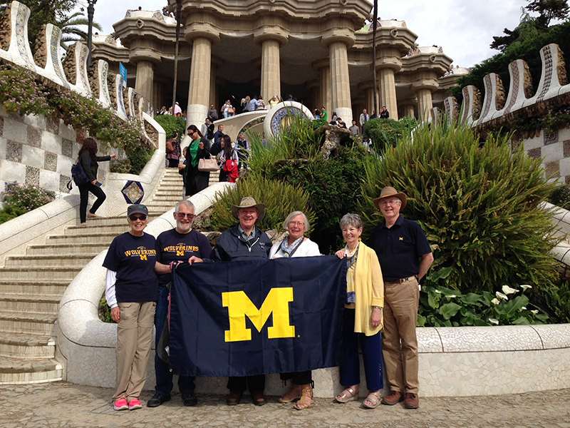 Six alumni proudly display their U-M flag in the Parc Guell of Barcelona, Spain. David, ’66, and Chady Hall, ’66 and Bob ’66, and Nona Pickering, ’67, celebrate their 50th anniversaries with Frank, MD’65, MDRES’69, and Bonnie Pauli, ’68.