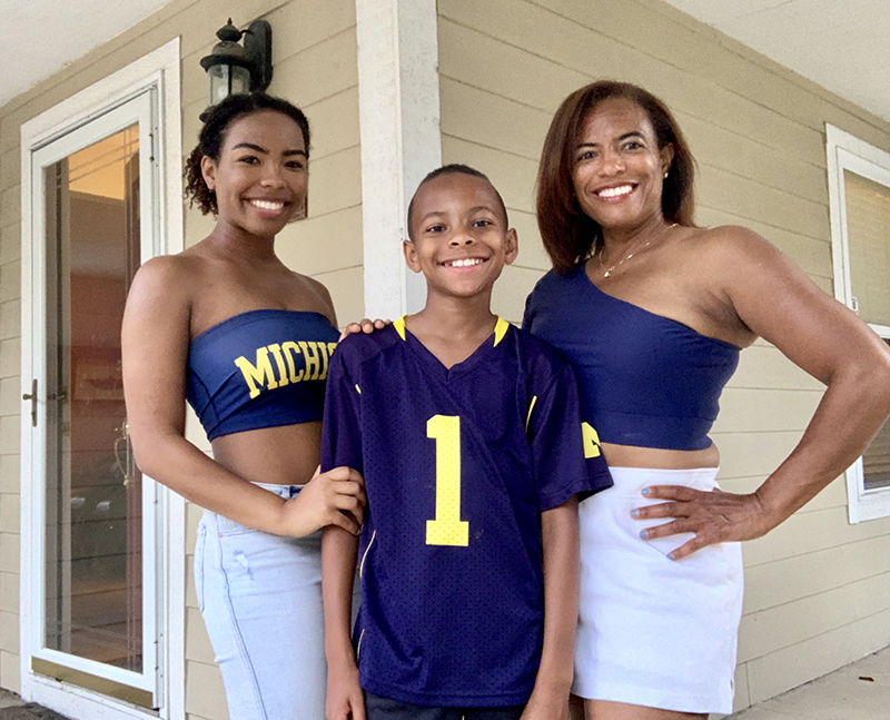 This past summer, Lisa Harrell Randon, ’92, MD’96, represented U-M at the Corktown Block Party in downtown Detroit with her daughter, current junior Peggy, and son, Daniel.
