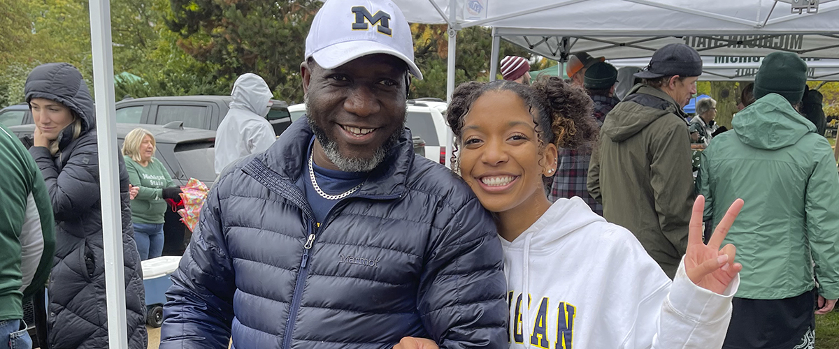 Adetola with her father, Adetunji Ojo, at a tailgate for the U-M vs. MSU Football Game in 2022.