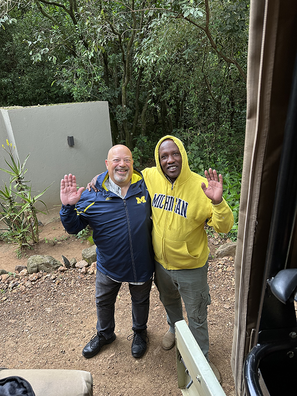 Sheldon Rich, ’81, gifted a U-M sweatshirt to his safari guide, Joseph Koyie, while visiting Nairobi, Kenya. While it was certainly given in appreciation for Joseph’s work, there was an ulterior motive. The guide mentioned that Michigan State University researchers were in the area to study hyenas, and Sheldon could not leave without responding to the Spartans.