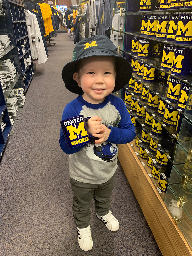 Dexter, the great-nephew of Debbie Simpkins, MA’77, visited the M Den in Ann Arbor. Upon find no mugs with Dexter’s name on it, his dad used a little digital magic to make a one-of-a-kind cup.