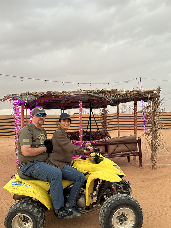 Tom Sullivan, MBA’23, braces as his wife, Reem, gets ready to take him for a spin during their camping trip in Saudi Arabia.