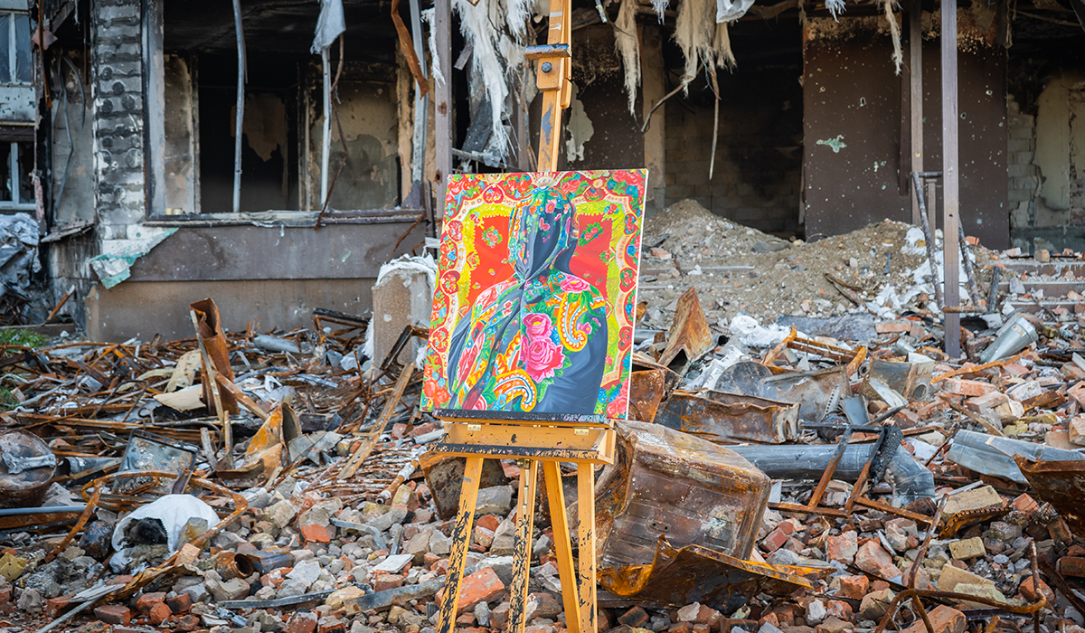 A painting staged amidst the ruins of a bombed-out building in Ukraine.