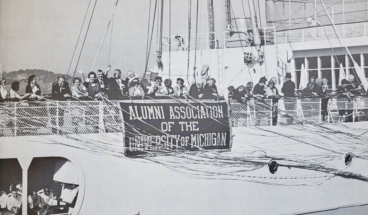 Black and white photograph of travelers on the 1966 cruise celebrating on the ship