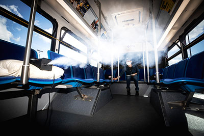 Kwang Hee Yoo, Michigan Engineering researcher, measures the flow of aerosols in a U-M blue bus in Ann Arbor.