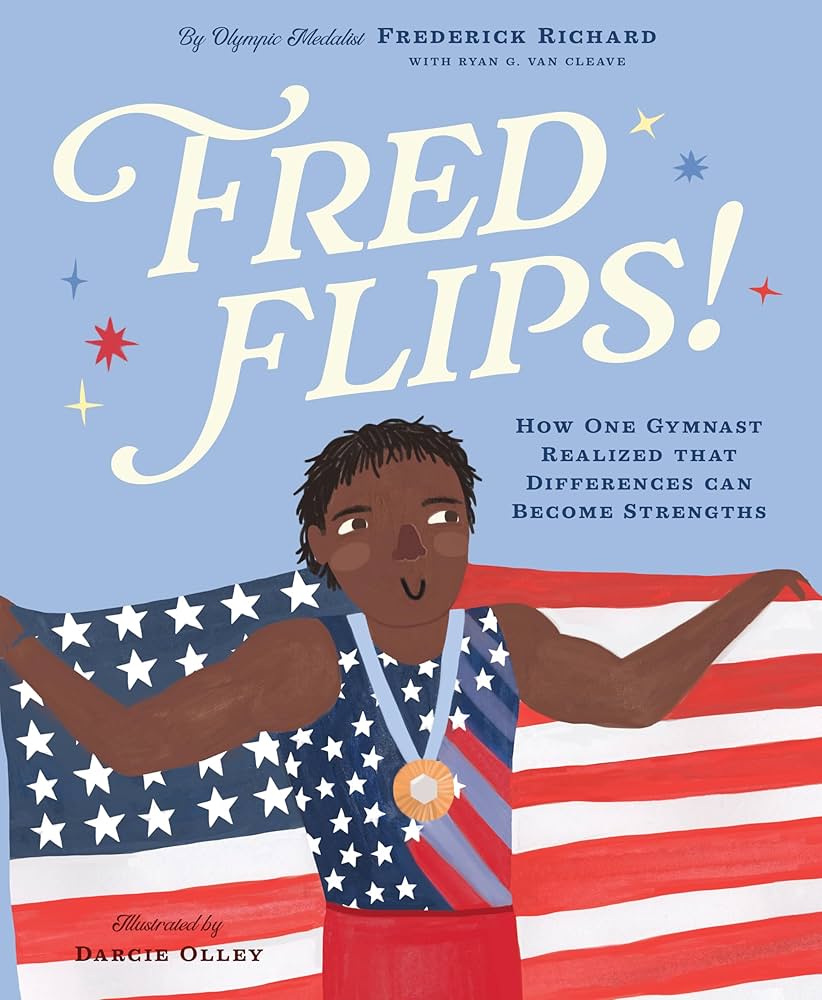 The cover of "Fred Flips!" which shows an illustrated version of Fred Richards in his competition uniform with a gold medal and holding an American flag.