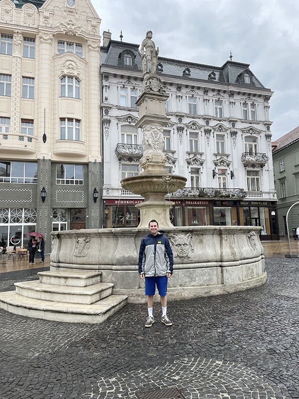 Jeffrey Zachem, ’20, took a moment to take a proud photo in the Main Square of the Old Town in Bratislava, Slovakia. Directly behind the Roland Fountain is the Palugyay palace; to the left is the palace of the Hungarian exchange bank.