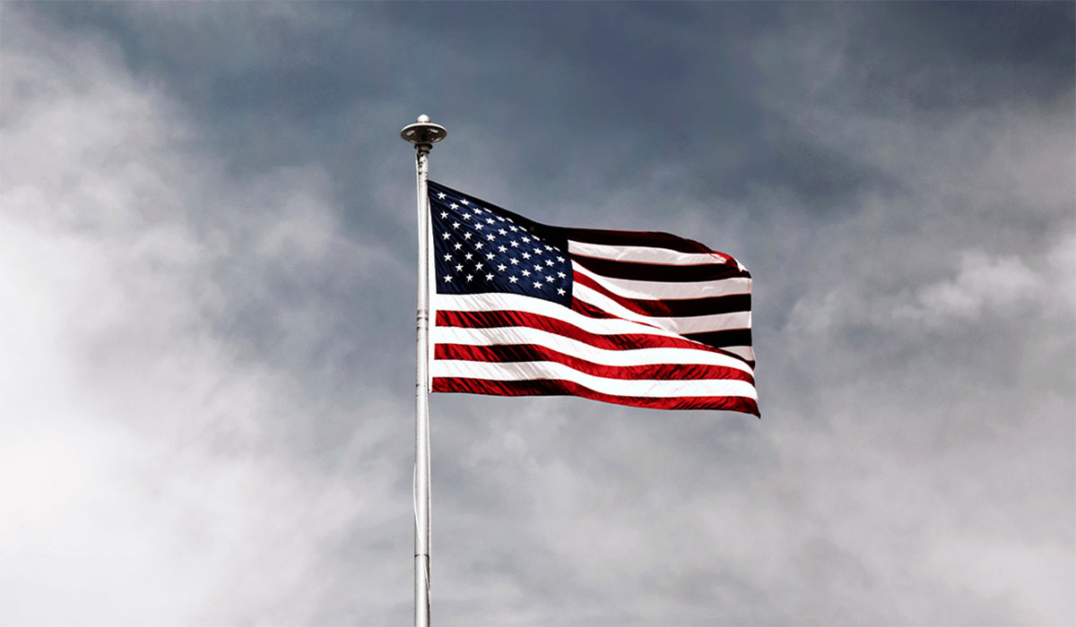 American Flag Gray Sky Pexels Featured 1090x681