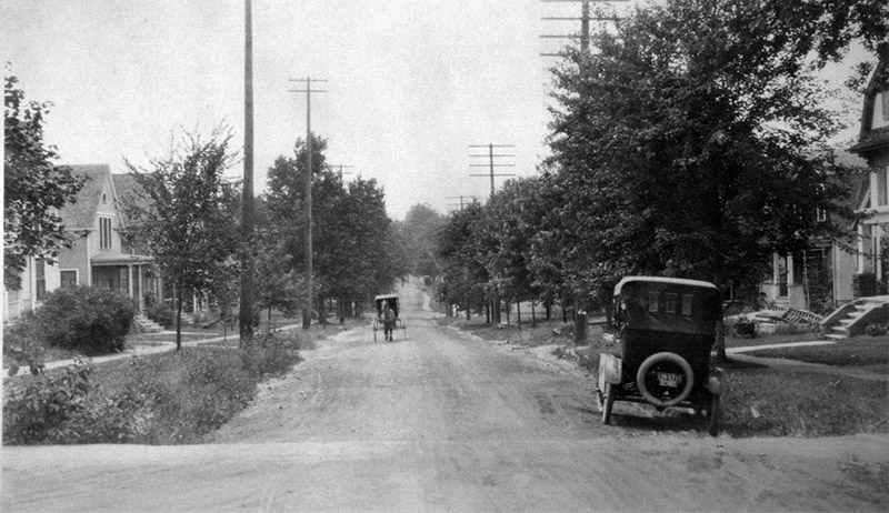 1920s: As the early 20th century rolled on, automobiles increasingly shared the street with horse-drawn buggies, as seen here at the intersection of Ann Street and Zina Pitcher Place (then called 14th Street), near the northwest corner of Couzens Hall.