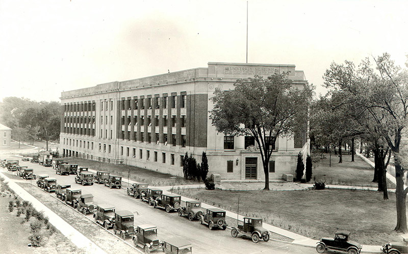 Early 1930s: Cars from Ann Arbor residents and U-M employees continued to line the streets around the University Museums Building (renamed the Alexander G. Ruthven Museums Building in 1968). Students increasingly criticized the ban, which was enforced on safety and moral grounds. The Michigan Daily—in an editorial titled “Moral Necessity?”—argued that the rule was more emotional than logical and that students should have access to “an acceptable instrument of social luxury,” given the small number of fatal accidents involving students.