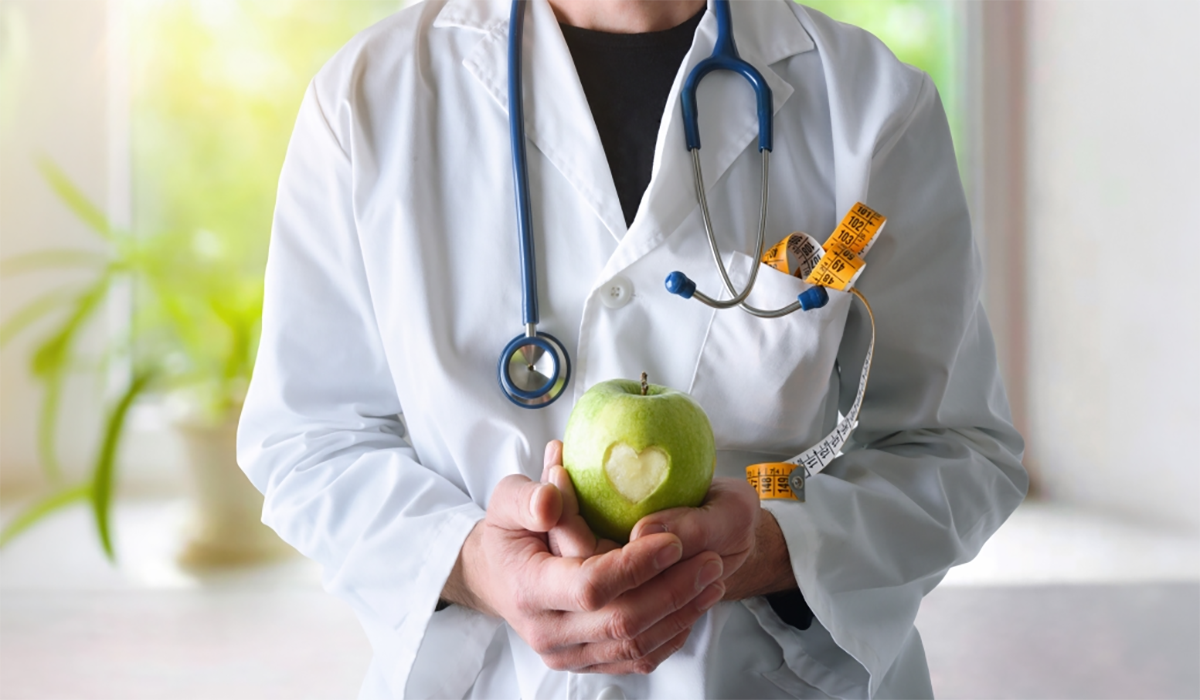 Doctor Holding Apple Heart Bite