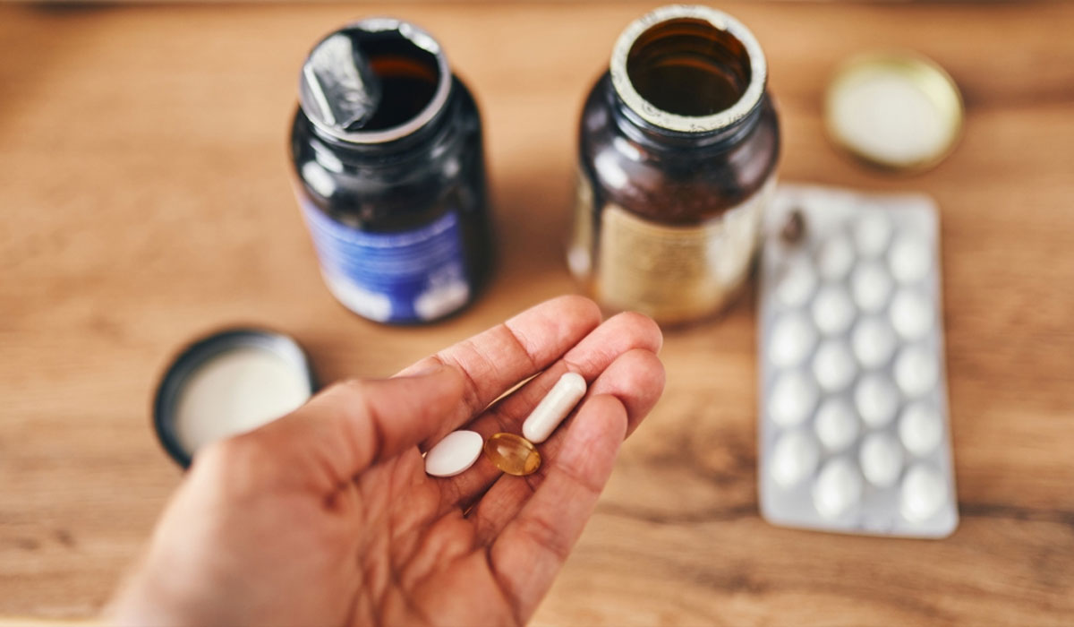 Hand Holding Pills Medications Bottles