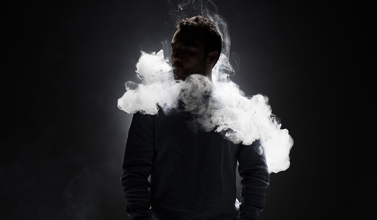 Man And Smoke Fragments On A Black Background