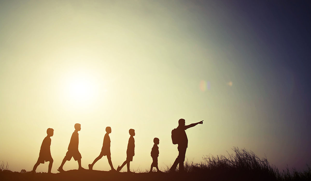 Silhouettes Children And Parent Walking With Backpacks. Time To Go Travel Together.