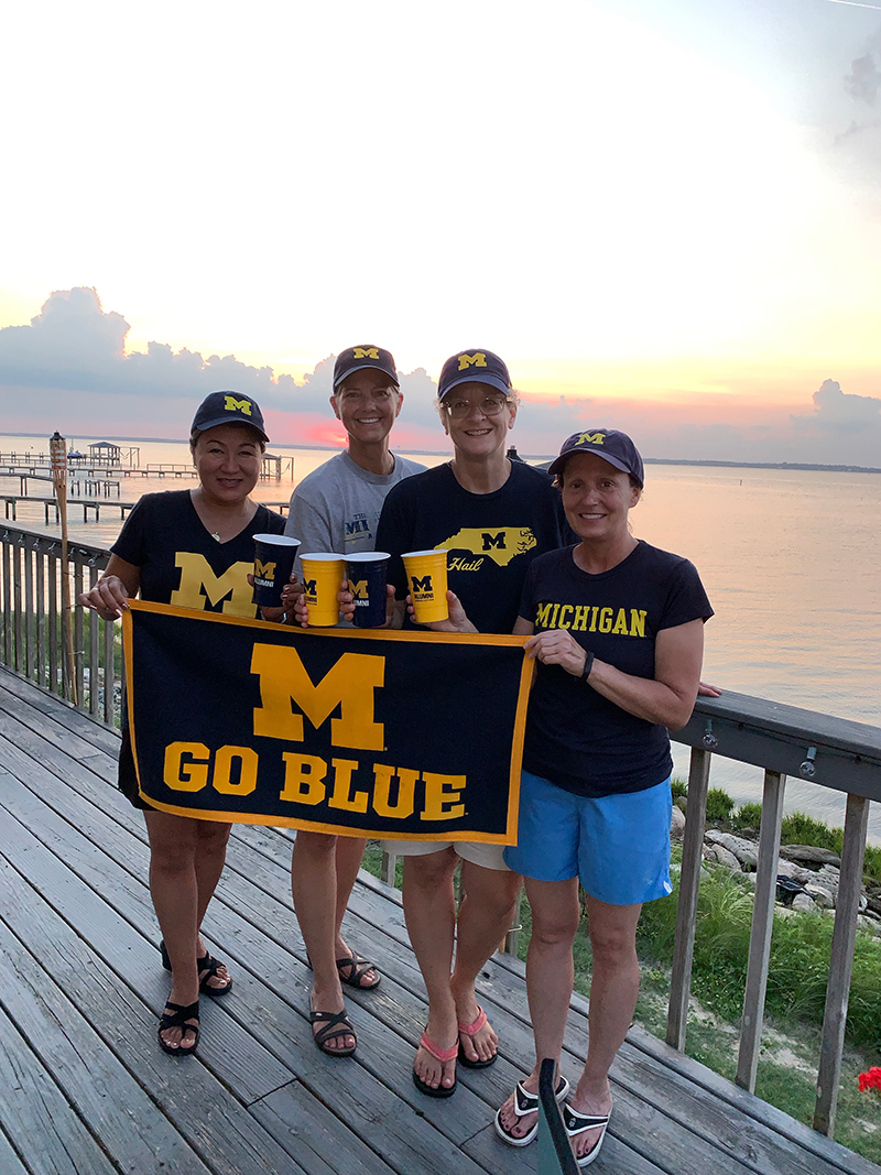 “The Kids Are Alright” as alumnae from Couzens Hall reunited at Bogue Sound in Emerald Isle, North Carolina, in July. From left to right: Alysa Watanabe Sakkas, ’85; Natalie Bush Marfleet, ’85; Margie Mordarski Newlin, ’85; and Kriste Fedon Mossman, ’85.