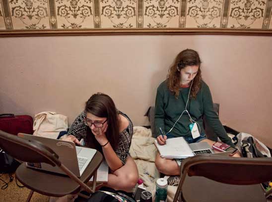 U-M sophomores Madison Helsel, left, and Megan Greenwood set up camp on the edge of the action in the Fountain Ballroom. About one-third of the students at MHacks were from U-M.