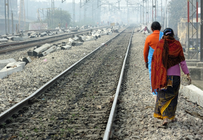 Category: Landscapes - Women on the railroad tracks in Varanasi, India (Photo by Chris Knaggs, ’75)