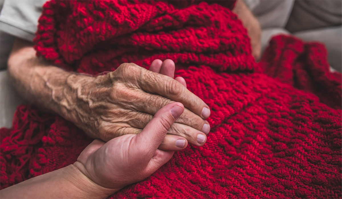 Senior Wrinkled Hand Holding Blanket 0