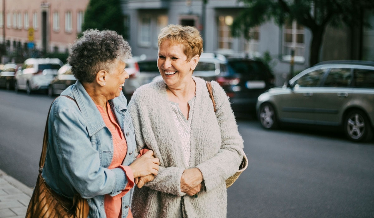 Two Older Women Smiling At Each Other