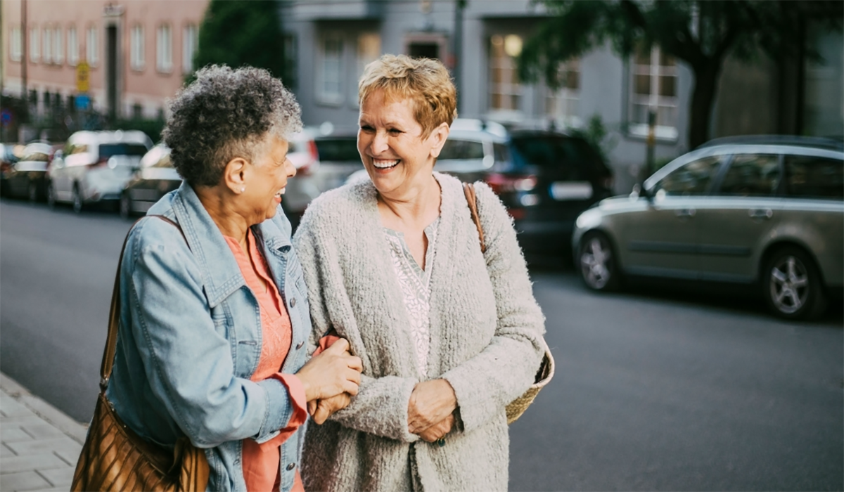 Two Older Women Smiling At Each Other