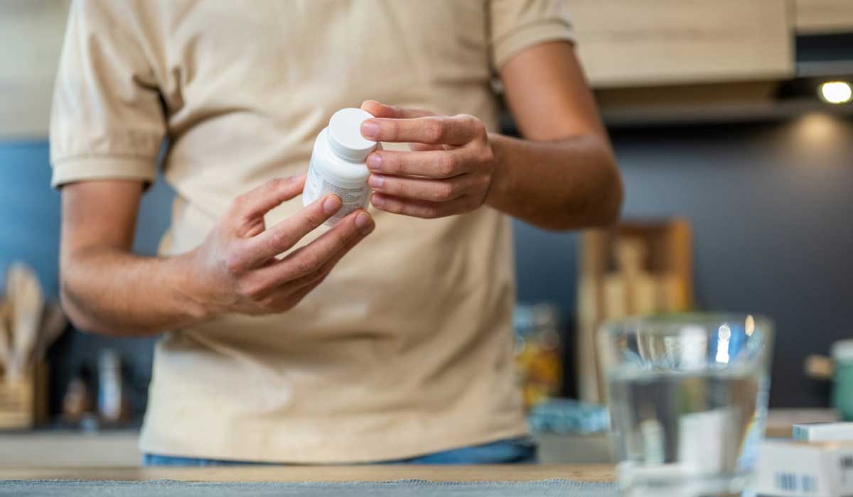 V2man Holding Prescription Pill Bottle