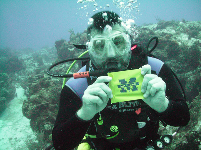 Jim Izen, ’89, shows Wolverine pride on a July 2016 dive at Paradise Reef in Cozumel, Mexico.